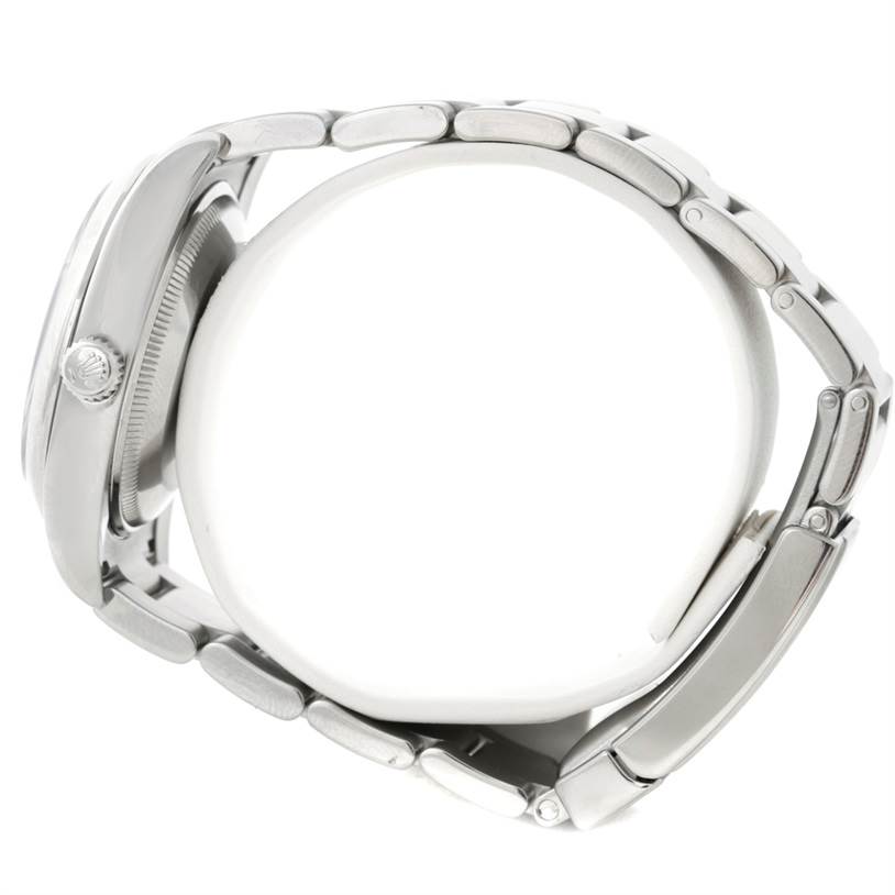 The image shows a side view of the Rolex Air-King 114200 Men's Stainless Steel Blue Dial 114200 Men's Stainless Steel Blue Dial watch, highlighting its bracelet and crown.