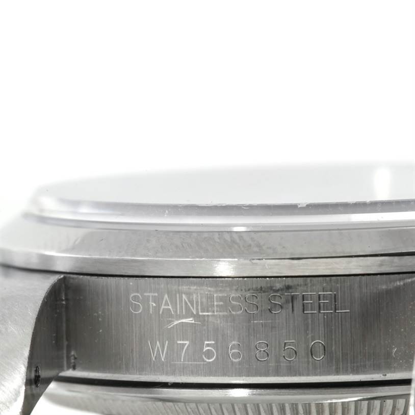 The image shows a close-up side view of the case and bezel of a Rolex Air-King 14000 Men's Stainless Steel White Dial 14000 Men's Stainless Steel White Dial watch, with an engraving that reads "STAINLESS STEEL" and the serial number.