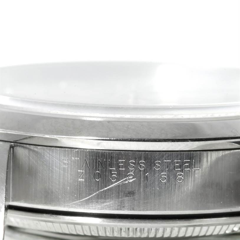 This image shows a close-up of the side of a Rolex Air-King 14000 Men's Stainless Steel Silver Dial 14000 Men's Stainless Steel Silver Dial watch case, highlighting the stainless steel material and engraved serial number.