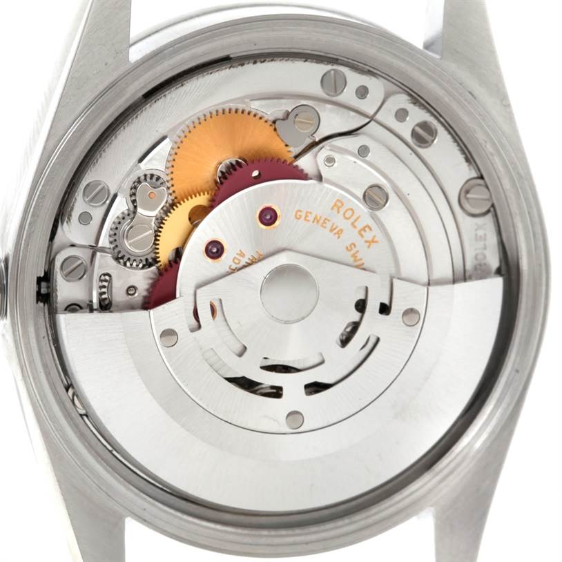 The image shows a close-up of the movement inside a Rolex Air-King 14000 Men's Stainless Steel Silver Dial 14000 Men's Stainless Steel Silver Dial watch, highlighting gears and internal components.