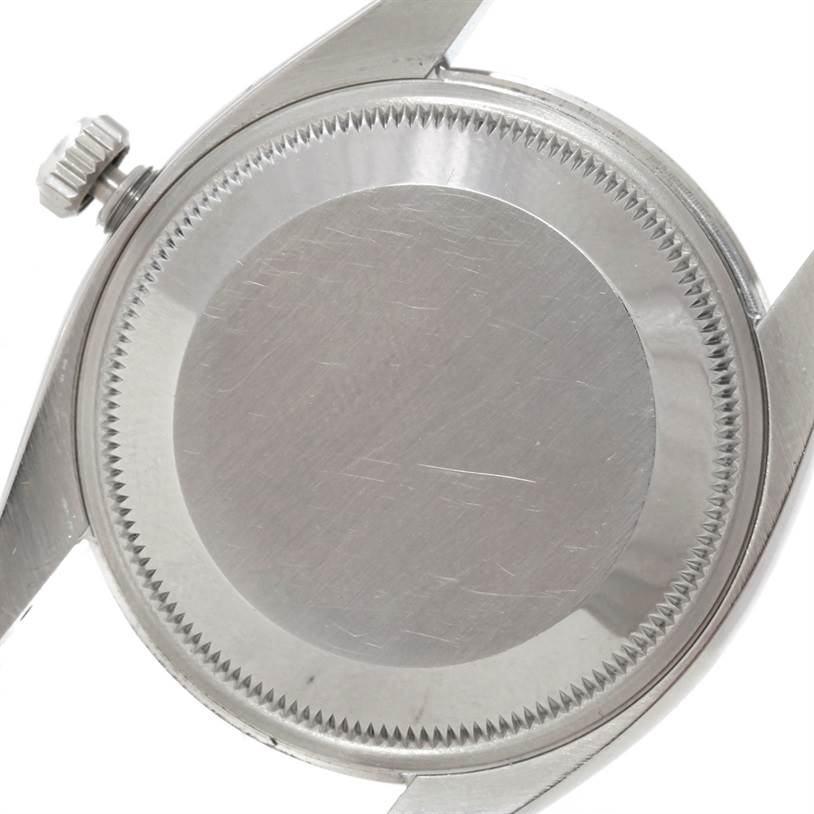 The image shows the back casing and crown of a Rolex Air-King 114200 Men's Stainless Steel Silver Dial 114200 Men's Stainless Steel Silver Dial watch from a rear angle.