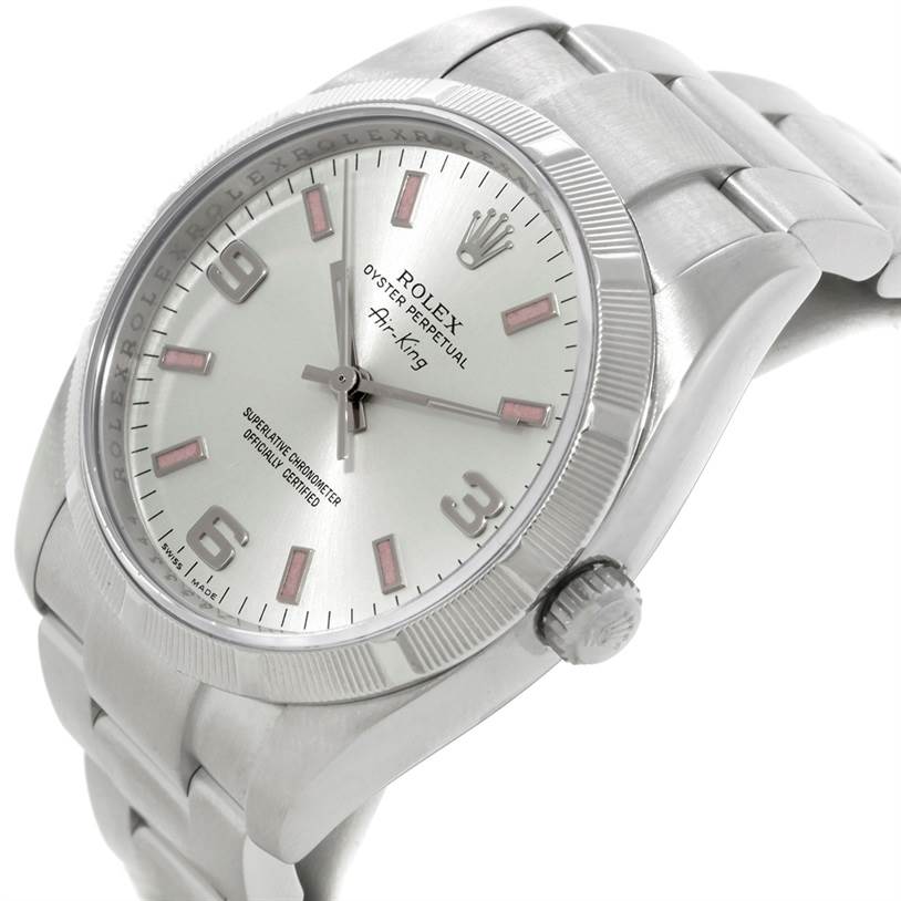 The image shows a tilted view of the Rolex Air-King 114200 Men's Stainless Steel Silver Dial 114200 Men's Stainless Steel Silver Dial watch displaying its face, bracelet, crown, and bezel.