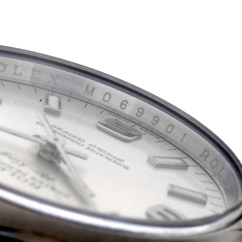 A close-up angle of the dial and rehaut of a Rolex Air-King 114200 Men's Stainless Steel Silver Dial 114200 Men's Stainless Steel Silver Dial watch is shown, highlighting the model number M069901.