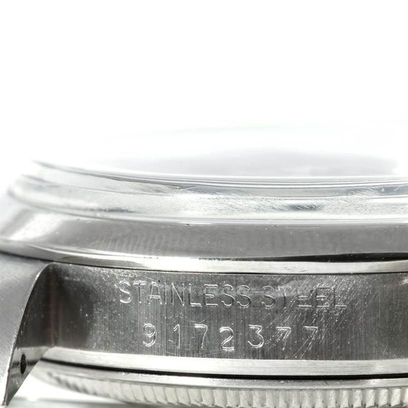 The image shows a close-up side view of the case, crystal, and lug of the Rolex Air-King 5700 Men's Stainless Steel Black Dial 5700 Men's Stainless Steel Black Dial watch, highlighting the serial number and "Stainless Steel" engraving.