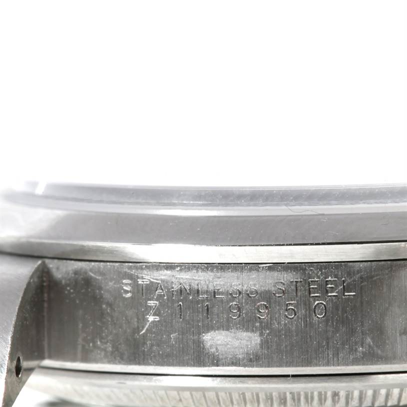 This close-up image shows the side of a Rolex Air-King 14000 Men's Stainless Steel Blue Dial 14000 Men's Stainless Steel Blue Dial watch case, highlighting the stainless steel material and serial number.