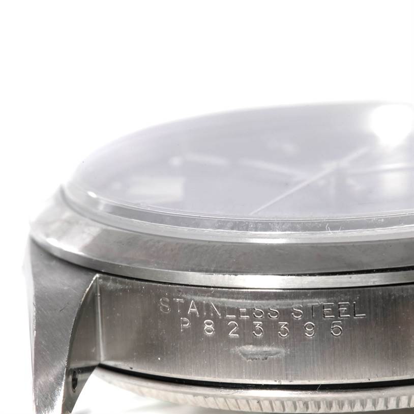 The image shows a side view of the stainless steel case, bezel, and serial number of a Rolex Air-King 14000 Men's Stainless Steel Blue Dial 14000 Men's Stainless Steel Blue Dial watch.