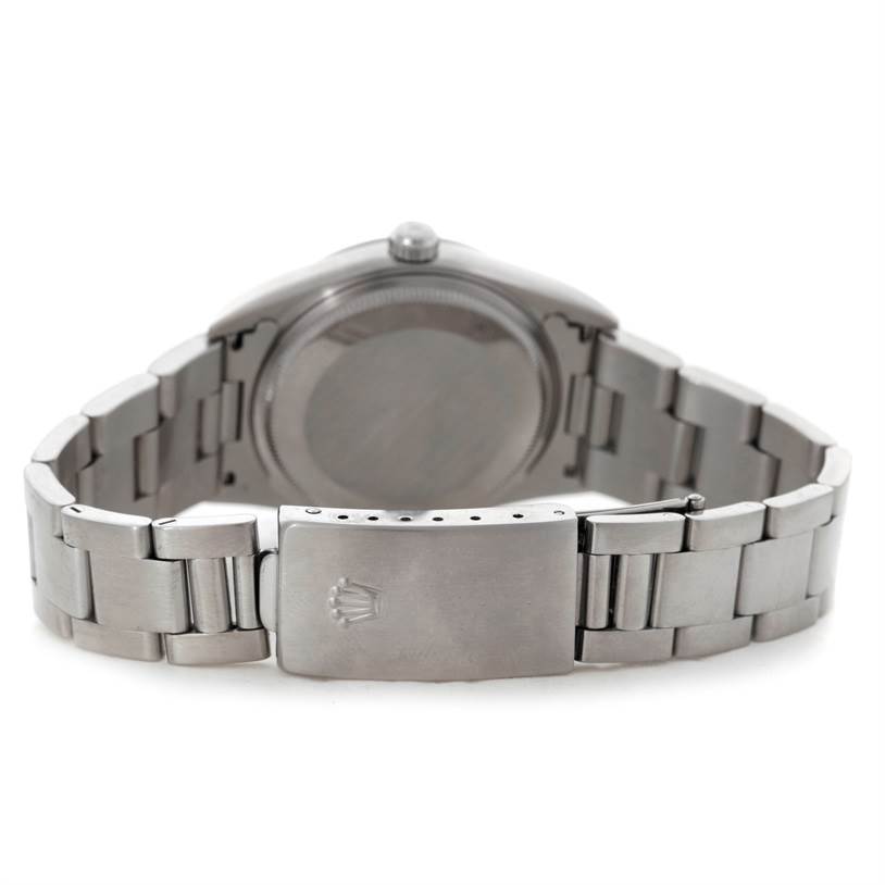 The image shows the backside of a Rolex Air-King 14000 Men's Stainless Steel Blue Dial 14000 Men's Stainless Steel Blue Dial watch, highlighting the case back and the clasp of the metal bracelet.