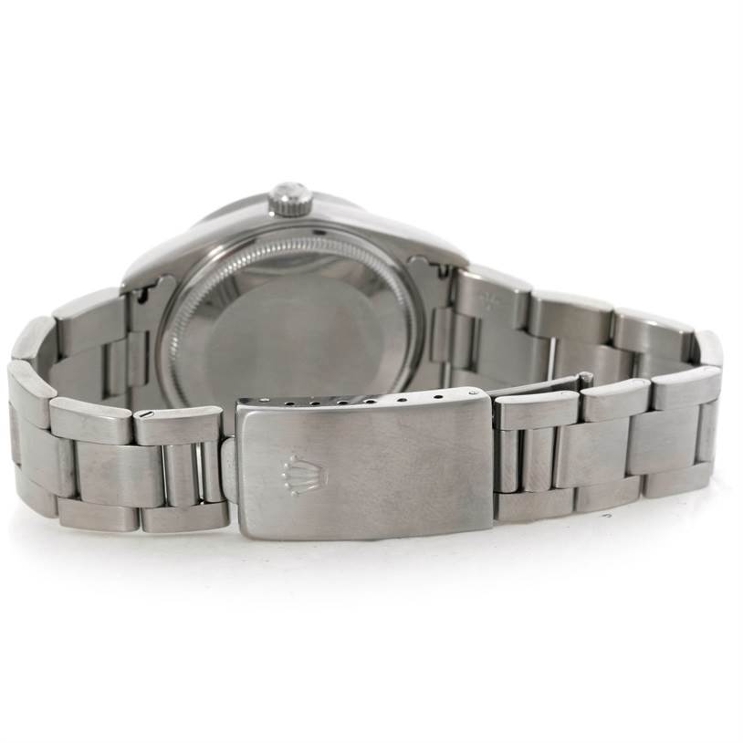 The image shows the back view of a Rolex Air-King 14010 Men's Stainless Steel Silver Dial 14010 Men's Stainless Steel Silver Dial watch, highlighting its case back and metal bracelet with a clasp.
