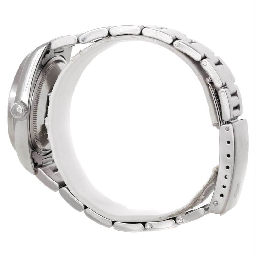 This side view of a Rolex Air-King 14010 Men's Stainless Steel Silver Dial 14010 Men's Stainless Steel Silver Dial watch highlights the bracelet links, crown, and part of the case.