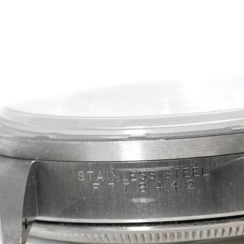 The image shows a close-up of the side of a Rolex Air-King 14010 Men's Stainless Steel Silver Dial 14010 Men's Stainless Steel Silver Dial watch, focusing on the stainless steel case and serial number.