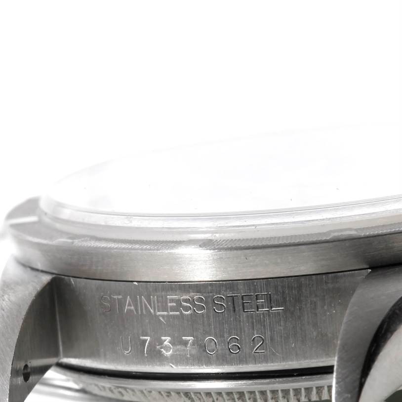 The image shows a close-up of the side of a Rolex Air-King 14010 Men's Stainless Steel Black Dial 14010 Men's Stainless Steel Black Dial watch, highlighting the stainless steel casing and serial number.