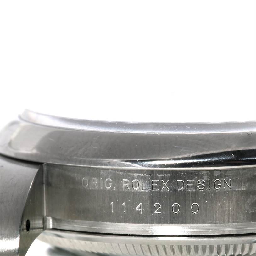 This is a close-up side view of a Rolex Air-King 114200 Men's Stainless Steel Blue Dial 114200 Men's Stainless Steel Blue Dial showing the model number 114200 and engraved "Orig. Rolex Design."