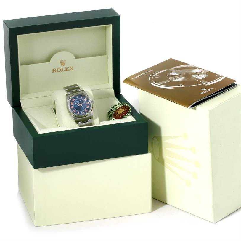 The image shows a Rolex Air-King 114200 Men's Stainless Steel Blue Dial 114200 Men's Stainless Steel Blue Dial watch in its box with accompanying booklet and tag, viewed from a front angle.