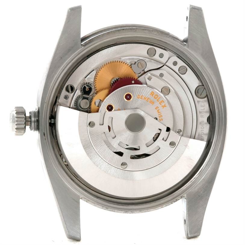 This image shows the internal mechanism of a Rolex Air-King 114200 Men's Stainless Steel Blue Dial 114200 Men's Stainless Steel Blue Dial watch with visible gears and the winding rotor.