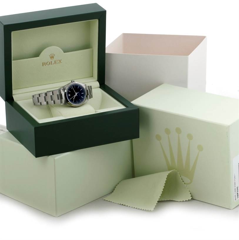 The Rolex Air-King 14000 Men's Stainless Steel Black Dial 14000 Men's Stainless Steel Black Dial watch is displayed in an open green box, with additional outer packaging and a cleaning cloth.