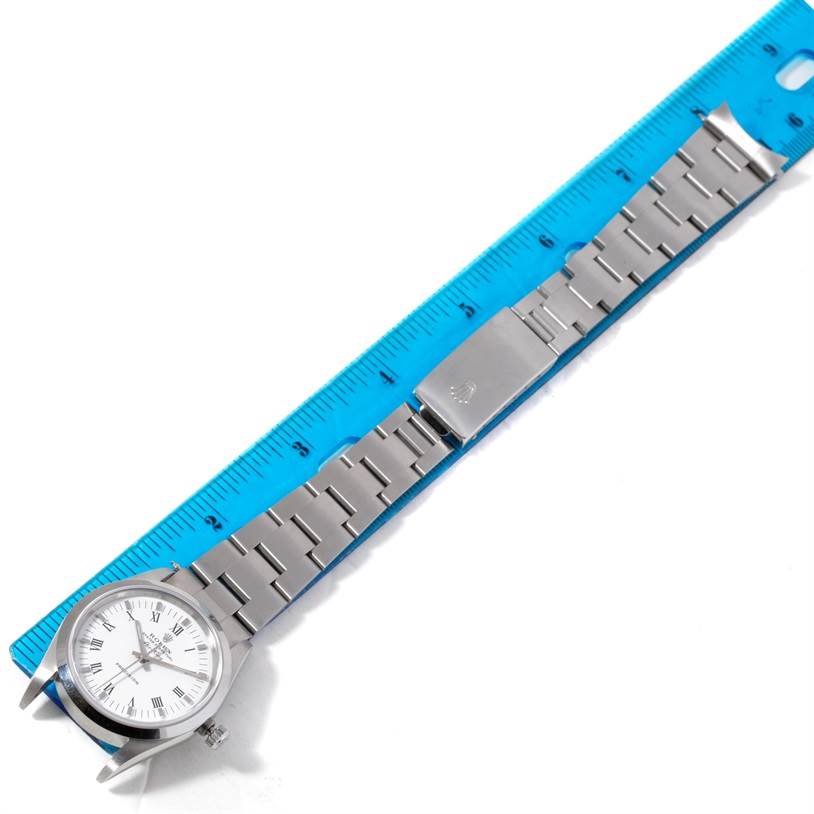 The image shows a Rolex Air-King 14000 Men's Stainless Steel White Dial 14000 Men's Stainless Steel White Dial watch at a top-down angle, featuring its face, bracelet, and clasp next to a ruler for scale.