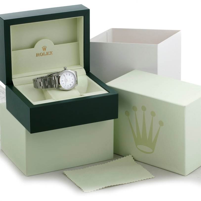 The Rolex Air-King 14000 Men's Stainless Steel White Dial 14000 Men's Stainless Steel White Dial watch is shown at an angled view inside its open, branded box, with additional packaging and a cleaning cloth visible.