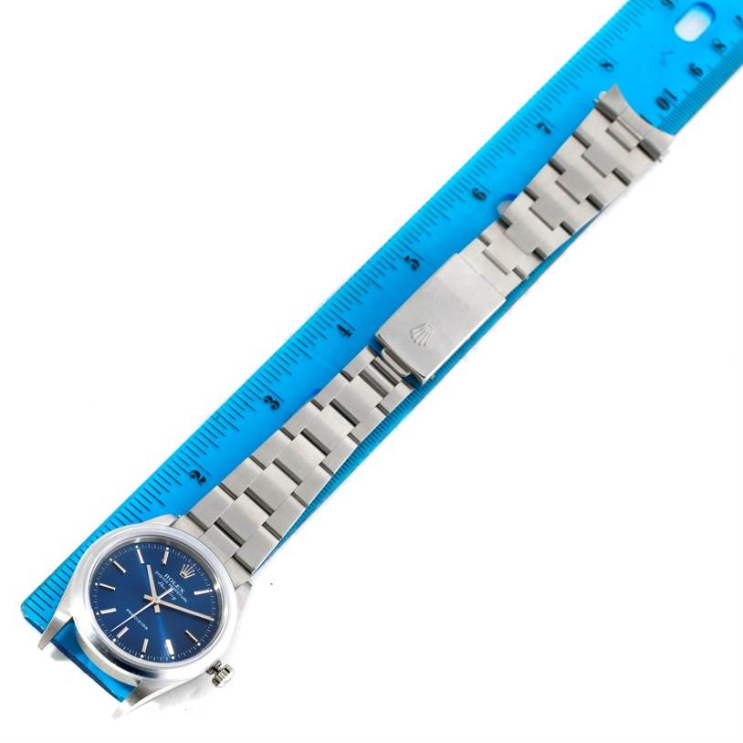 The Rolex Air-King 14000 Men's Stainless Steel Blue Dial 14000 Men's Stainless Steel Blue Dial watch is shown flat on a ruler, highlighting its bracelet, clasp, and face.