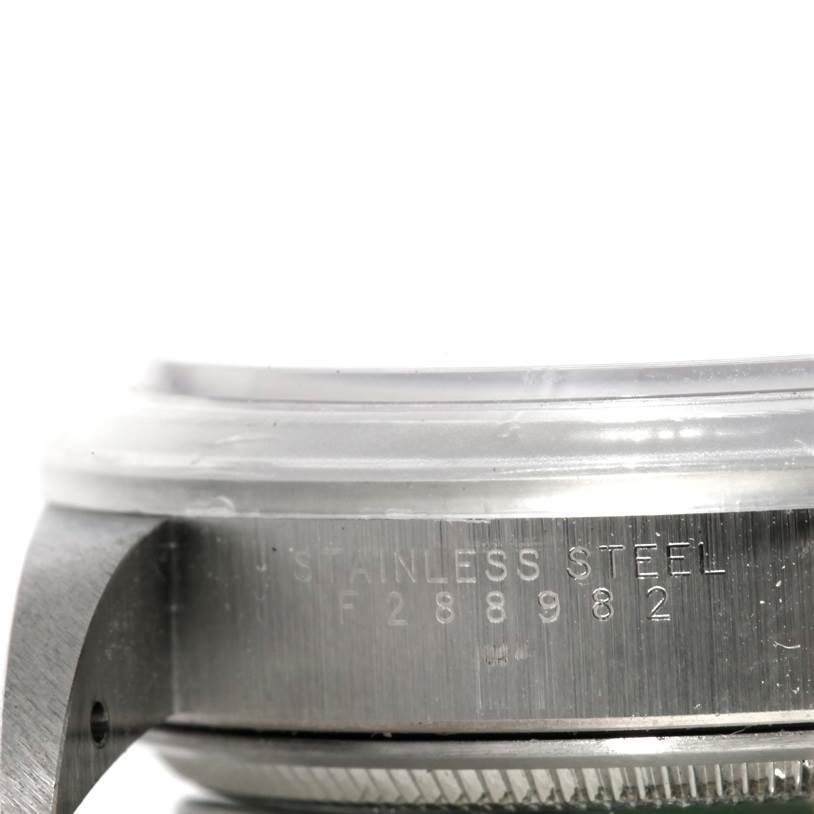 The image shows a close-up side view of a Rolex Air-King 14000 Men's Stainless Steel Blue Dial 14000 Men's Stainless Steel Blue Dial watch with the stainless steel case and part of its serial number visible.