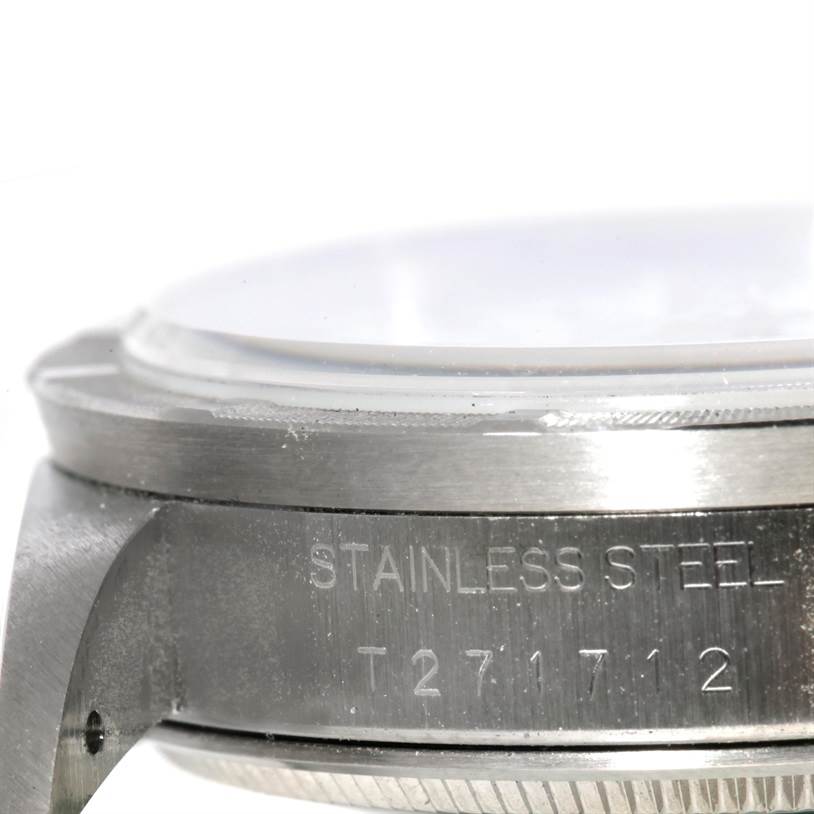 The image shows a close-up side view of the stainless steel case of a Rolex Air-King 14010 Men's Stainless Steel White Dial 14010 Men's Stainless Steel White Dial watch, focusing on the engraved serial number.