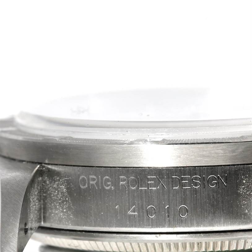 The image shows a close-up side view of the bezel and case edge of a Rolex Air-King 14010 Men's Stainless Steel White Dial 14010 Men's Stainless Steel White Dial watch, highlighting its engraving.