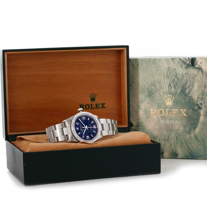 This image shows a Rolex Air-King 14010 Men's Stainless Steel Blue Dial 14010 Men's Stainless Steel Blue Dial watch with a blue dial, displayed in an open wooden box with the packaging alongside it.