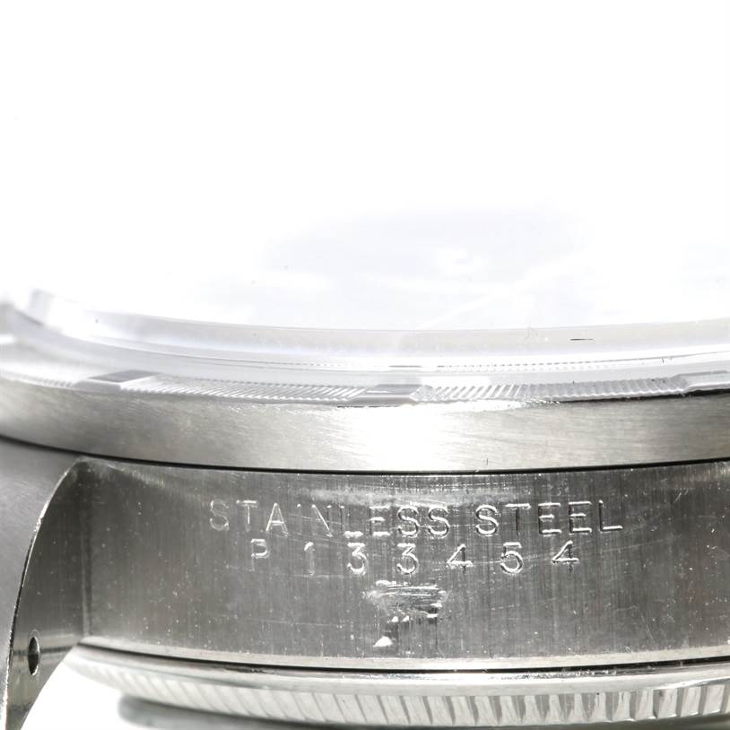 This close-up image shows the side view of a Rolex Air-King 14010 Men's Stainless Steel Blue Dial 14010 Men's Stainless Steel Blue Dial watch, highlighting the stainless steel case and engraved serial number.