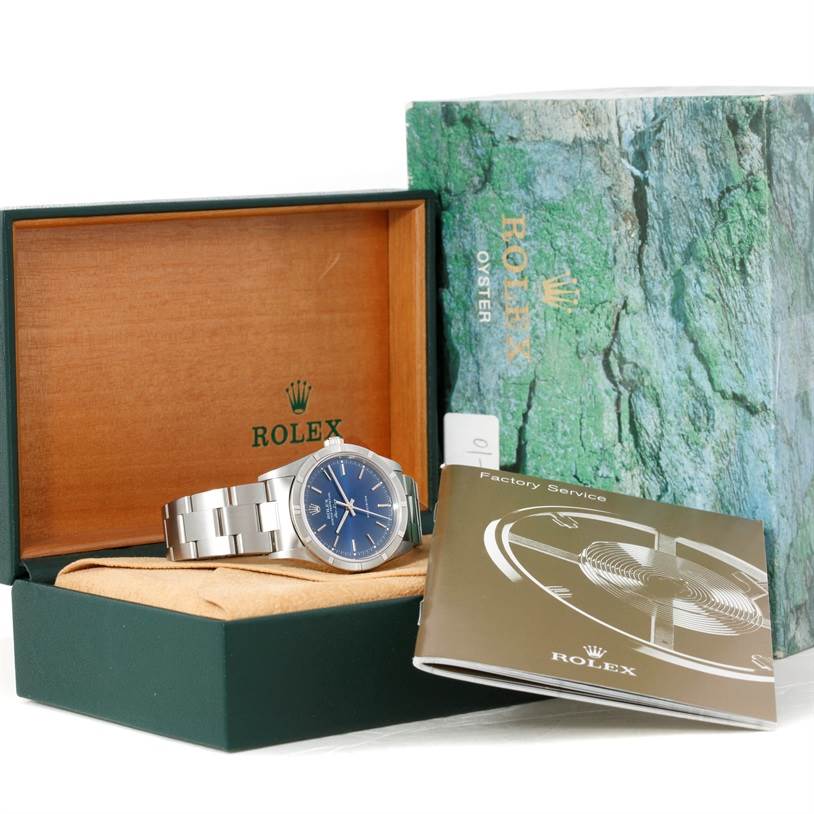 The image shows a Rolex Air-King 14010 Men's Stainless Steel Blue Dial 14010 Men's Stainless Steel Blue Dial watch in its open box with the instruction manual and outer packaging visible.