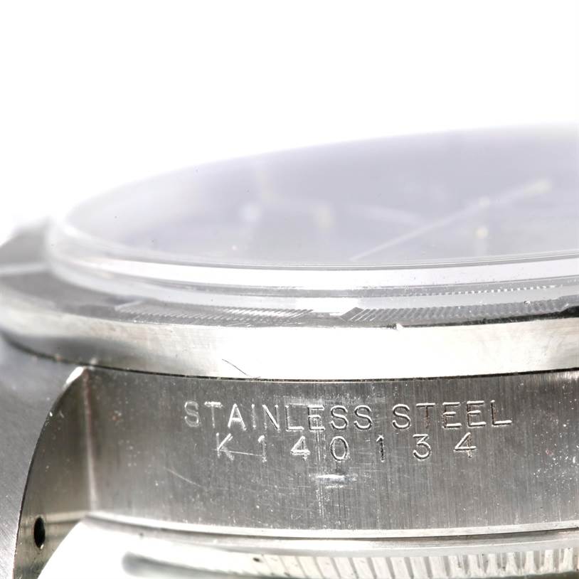 This image shows a close-up side view of the stainless steel case of a Rolex Air-King 14010 Men's Stainless Steel Blue Dial 14010 Men's Stainless Steel Blue Dial watch, highlighting its serial number engraving.