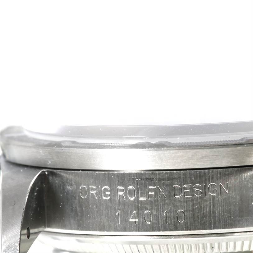 The image shows the side view of a Rolex Air-King 14010 Men's Stainless Steel Blue Dial 14010 Men's Stainless Steel Blue Dial watch, focusing on the case with engraved details.