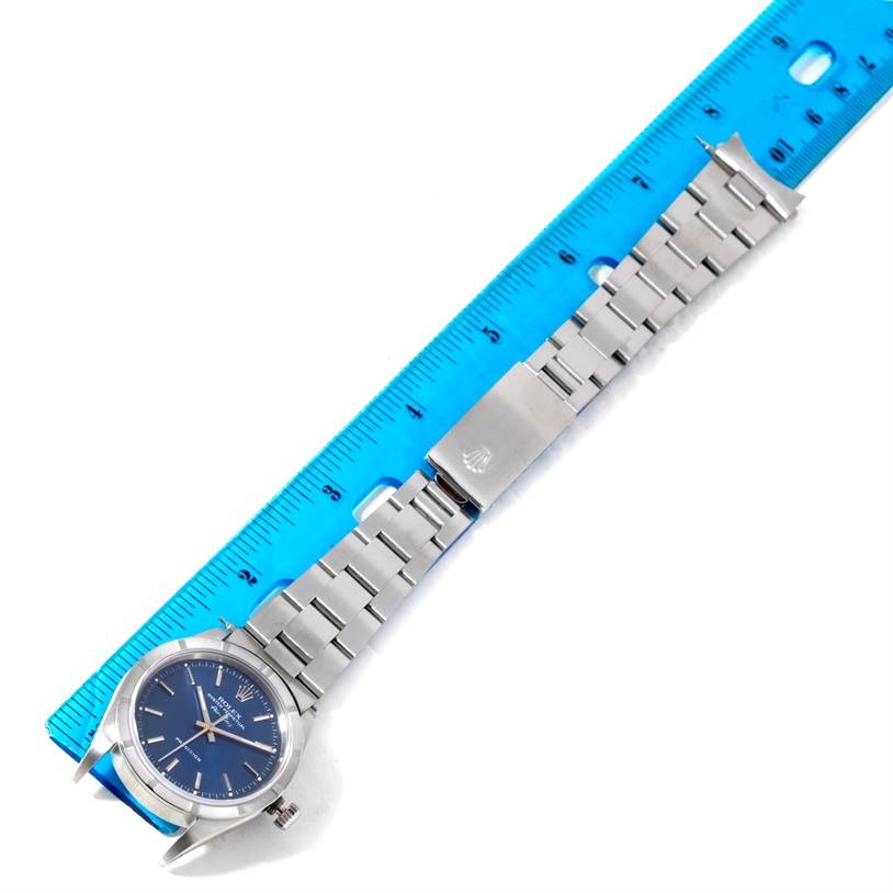 The image shows a Rolex Air-King 14010 Men's Stainless Steel Blue Dial 14010 Men's Stainless Steel Blue Dial watch laid flat alongside a ruler, displaying the face, bracelet, and clasp.