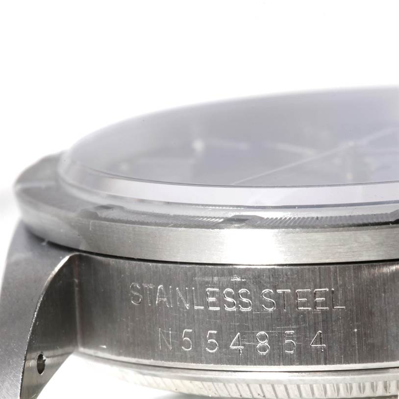 The image shows a close-up side angle of a Rolex Air-King 14010 Men's Stainless Steel Blue Dial 14010 Men's Stainless Steel Blue Dial watch, highlighting the stainless steel casing and serial number.