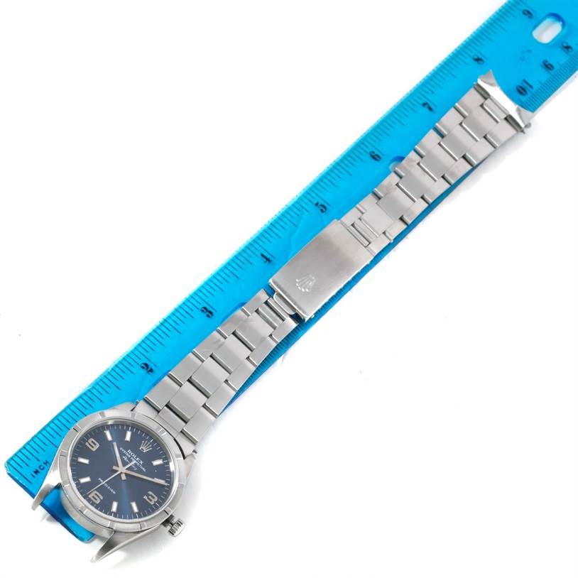 The image shows a Rolex Air-King 14010 Men's Stainless Steel Blue Dial 14010 Men's Stainless Steel Blue Dial watch laid flat, with its bracelet fully extended alongside a blue ruler for size reference.