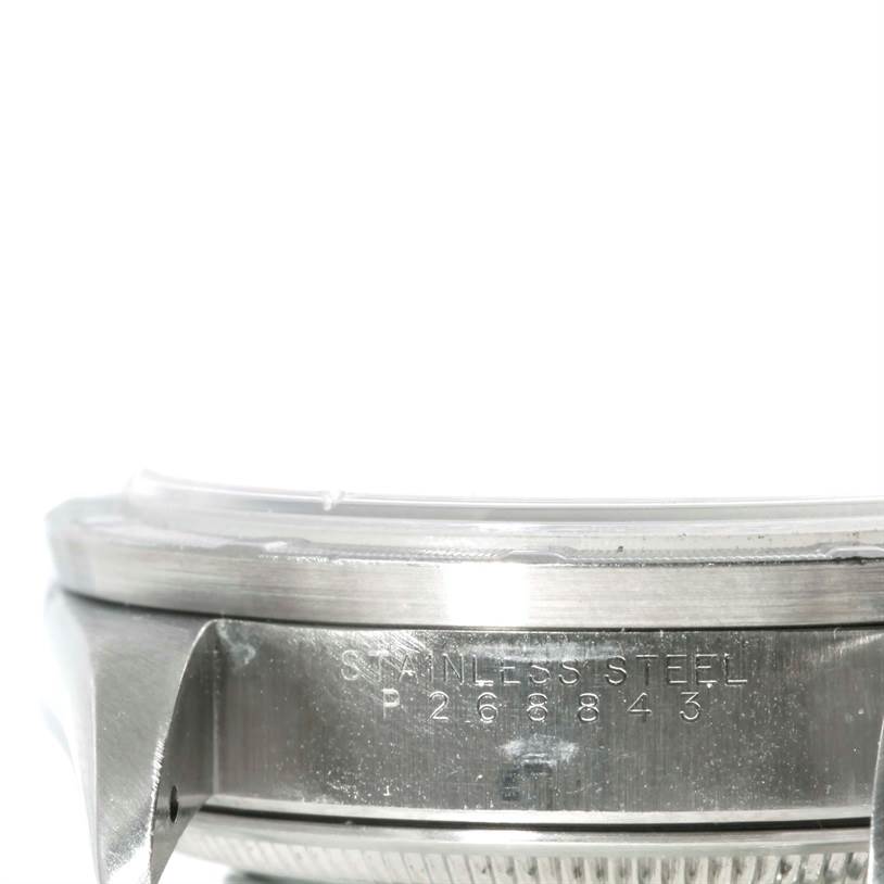 The image shows a close-up of the side view of a Rolex Air-King 14010 Men's Stainless Steel Blue Dial 14010 Men's Stainless Steel Blue Dial watch, highlighting the stainless steel case and serial number.