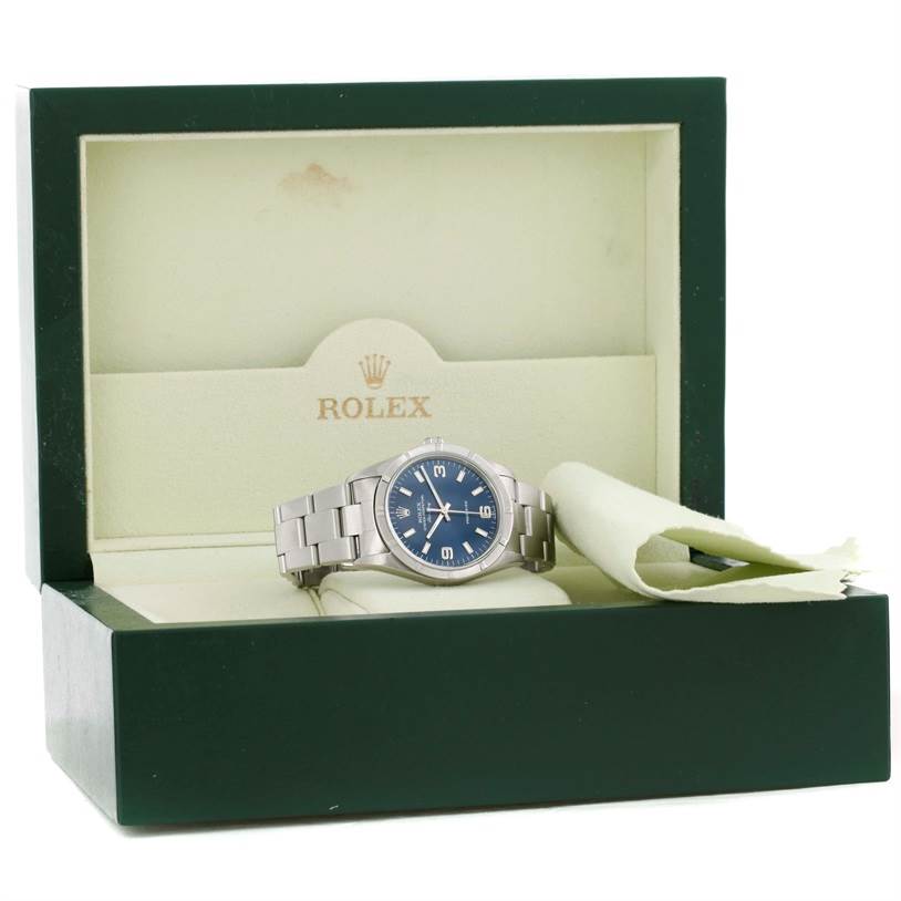 The image shows a Rolex Air-King 14010 Men's Stainless Steel Blue Dial 14010 Men's Stainless Steel Blue Dial watch with a blue dial and stainless steel bracelet in its open green display box.
