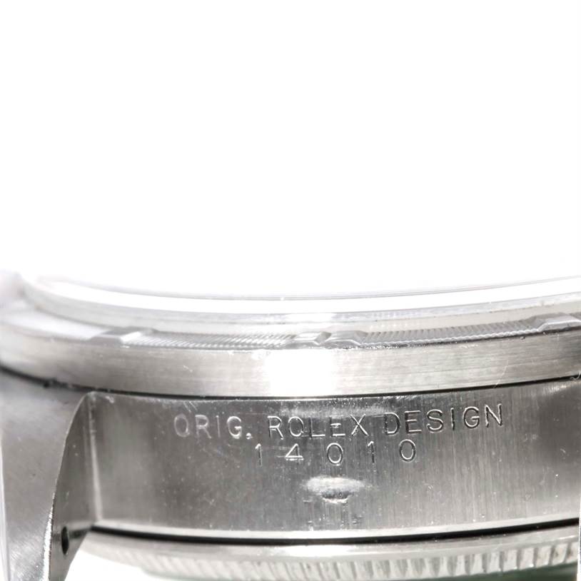 The image shows a close-up of the side of a Rolex Air-King 14010 Men's Stainless Steel Blue Dial 14010 Men's Stainless Steel Blue Dial watch model, focusing on its branded inscription and stainless steel case.