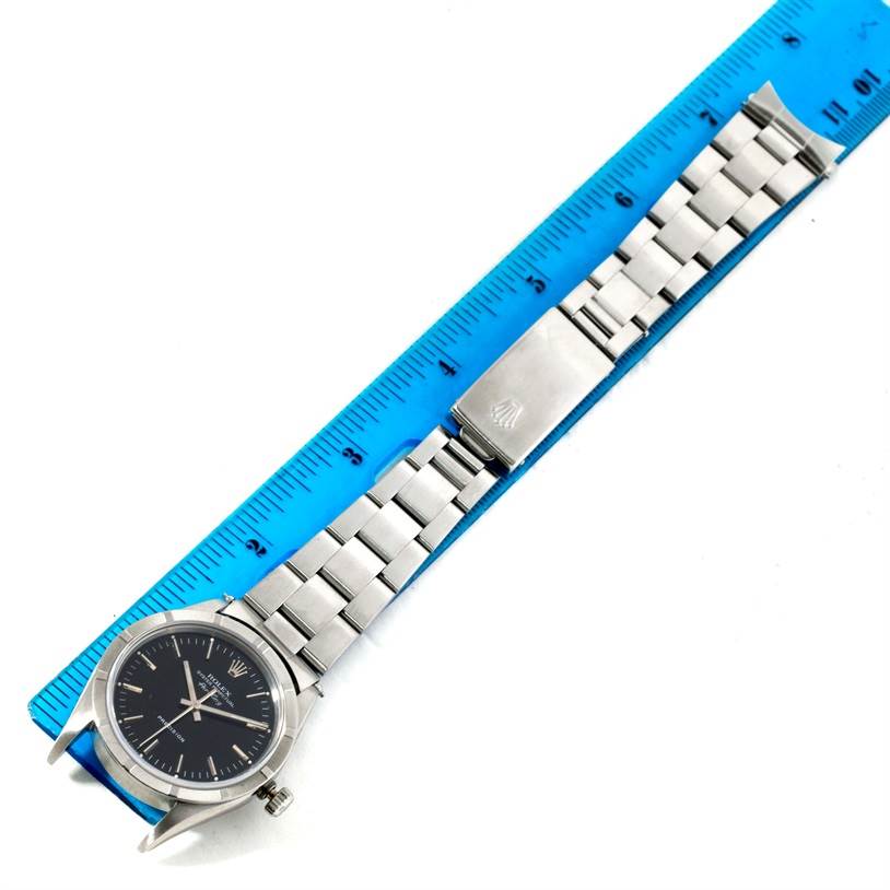 The image shows a Rolex Air-King 14010 Men's Stainless Steel Black Dial 14010 Men's Stainless Steel Black Dial watch laid flat next to a ruler, displaying the face, bracelet, and clasp.