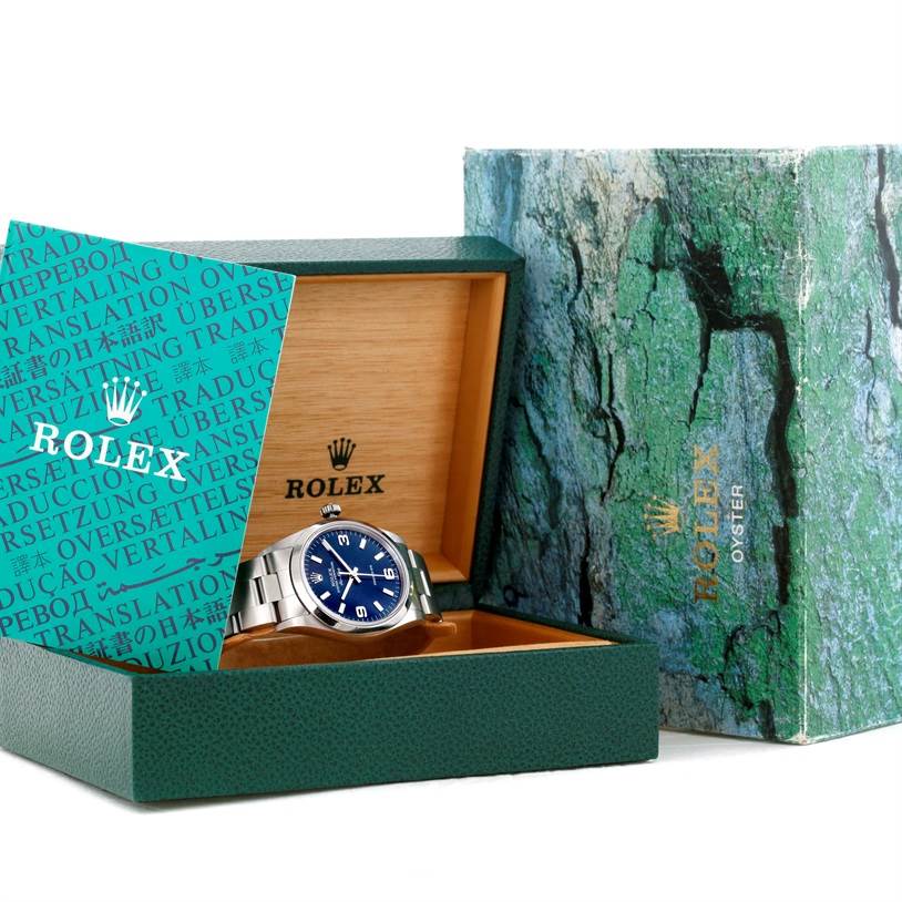 The image shows a Rolex Air-King 14000 Men's Stainless Steel Blue Dial 14000 Men's Stainless Steel Blue Dial watch partially inside its open box with visible packaging.