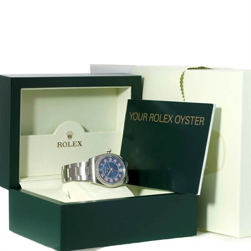 The Rolex Air-King 114210 Men's Stainless Steel Blue Dial 114210 Men's Stainless Steel Blue Dial watch is displayed in its box with accompanying documentation, viewed from a forward angle.