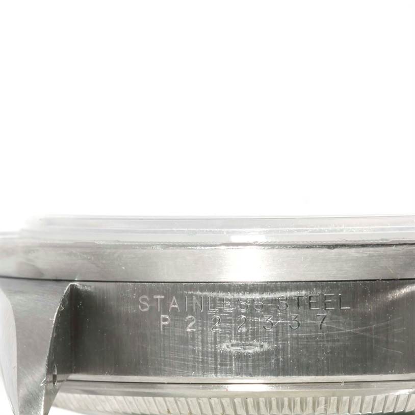 This image shows a close-up side view of the case back and part of the stainless steel bezel of a Rolex Air-King 14010 Men's Stainless Steel White Dial 14010 Men's Stainless Steel White Dial watch.