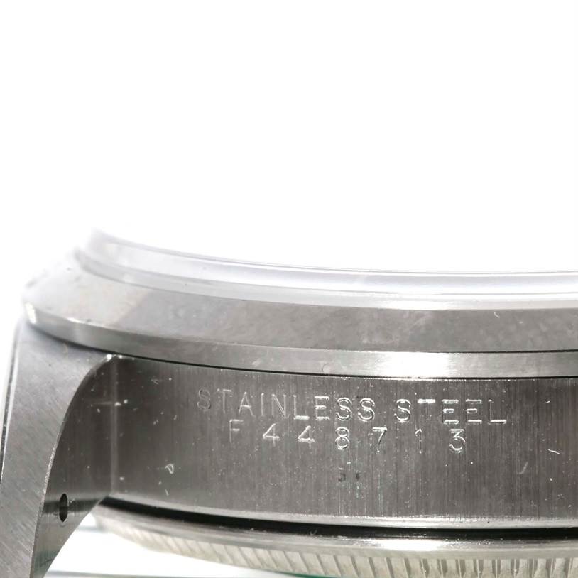 The image shows a close-up of the case side of a Rolex Air-King 14000 Men's Stainless Steel Silver Dial 14000 Men's Stainless Steel Silver Dial watch in stainless steel, highlighting the model and serial number engraving.