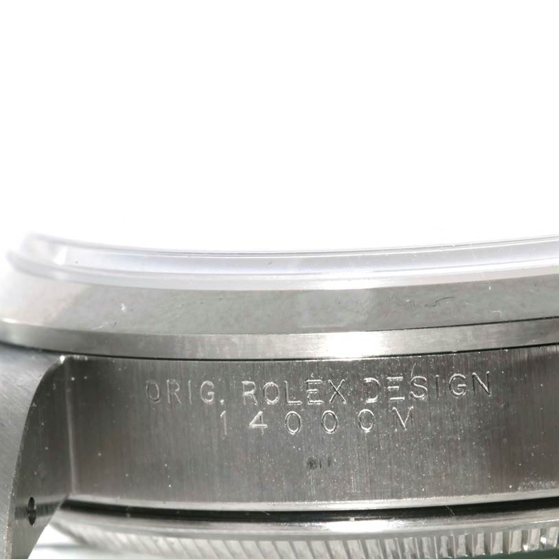 This close-up image shows the side view of the Rolex Air-King 14000 Men's Stainless Steel Silver Dial 14000 Men's Stainless Steel Silver Dial watch case with its "Orig. Rolex Design" engraving and model number (14000M).