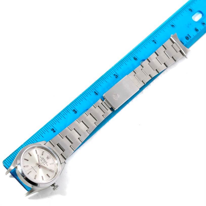 The image shows the Rolex Air-King 14000 Men's Stainless Steel Silver Dial 14000 Men's Stainless Steel Silver Dial watch laid flat next to a ruler, displaying the dial and metal bracelet band.