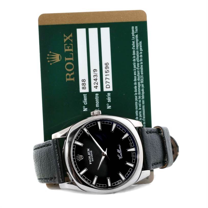 This Rolex Cellini 4243 Men's White Gold Black Dial 4243 Men's White Gold Black Dial watch is shown from the front, displaying its black dial, silver markers, and partially visible leather strap with a card behind it.