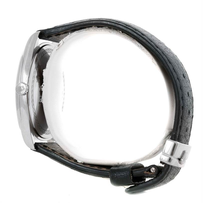 This side view of the Rolex Cellini 4243 Men's White Gold Black Dial 4243 Men's White Gold Black Dial watch shows the case, crown, and leather strap with buckle.