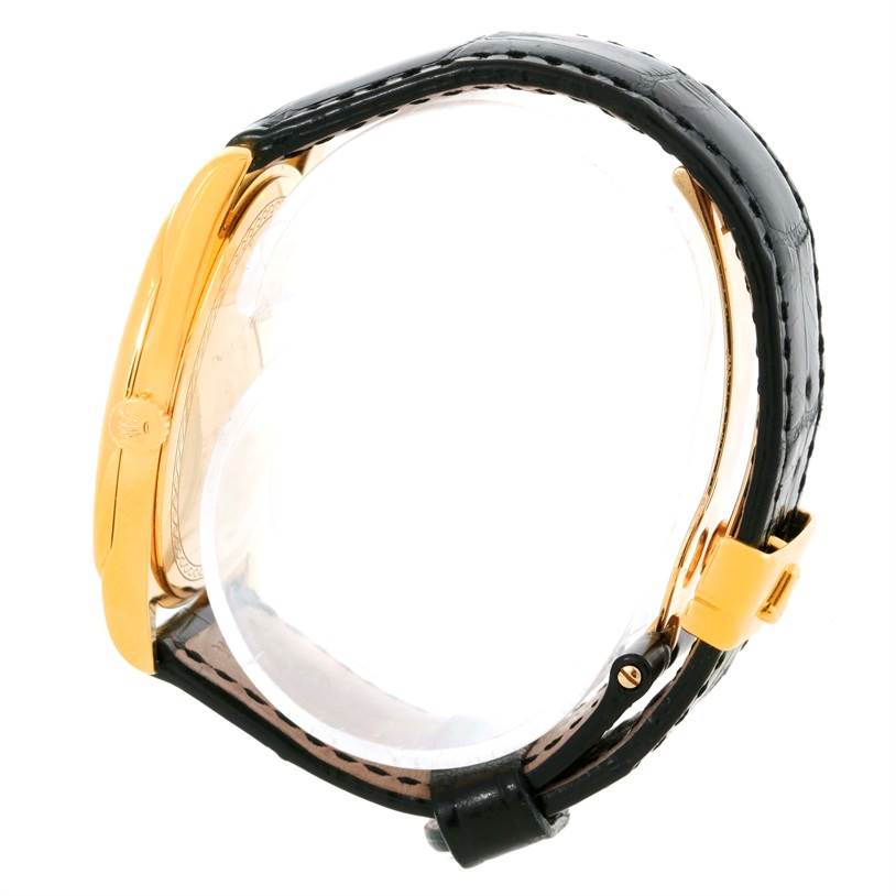 The Rolex Cellini 4243 Men's Yellow Gold White Dial 4243 Men's Yellow Gold White Dial watch is shown from the side, displaying the gold case, black leather strap, crown, and buckle.