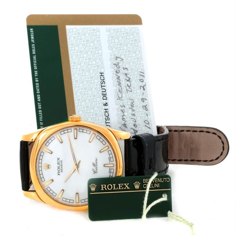 The Rolex Cellini 4243 Men's Yellow Gold White Dial 4243 Men's Yellow Gold White Dial watch is shown from a front angle, along with its strap, tag, and authenticity card.