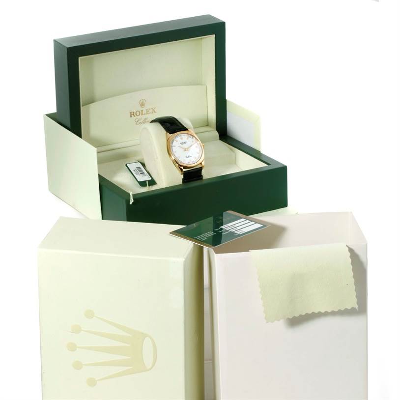 The image shows a Rolex Cellini 4243 Men's Yellow Gold White Dial 4243 Men's Yellow Gold White Dial watch inside its open box, with an outer box and a cleaning cloth visible.