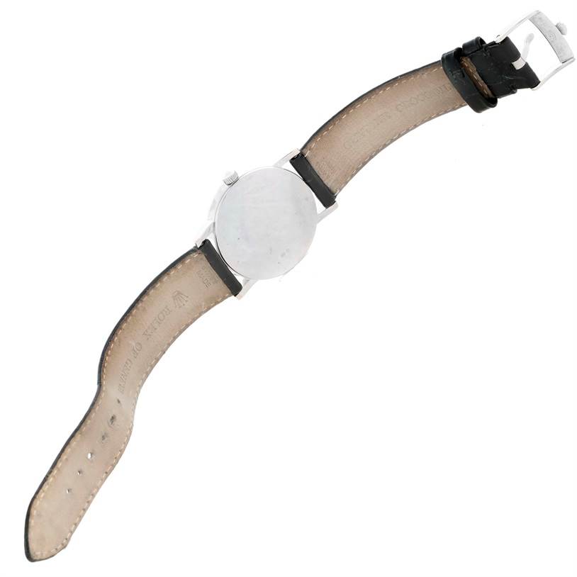 The image shows the back view of a Rolex Cellini 5116 Men's White Gold Silver Dial 5116 Men's White Gold Silver Dial watch, highlighting its case and leather strap with buckle.