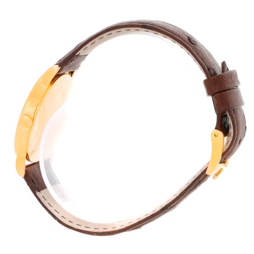 The image shows a side view of a Rolex Cellini 5115 Men
s Yellow Gold Silver Dial 5115 Men
s Yellow Gold Silver Dial watch, focusing on the gold case and brown leather strap.